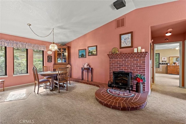 dining area featuring carpet floors and vaulted ceiling