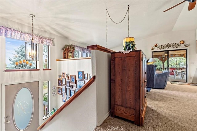 interior space featuring an inviting chandelier, a wealth of natural light, and carpet