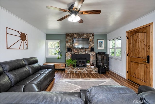 living room featuring crown molding, a wealth of natural light, and dark wood-type flooring