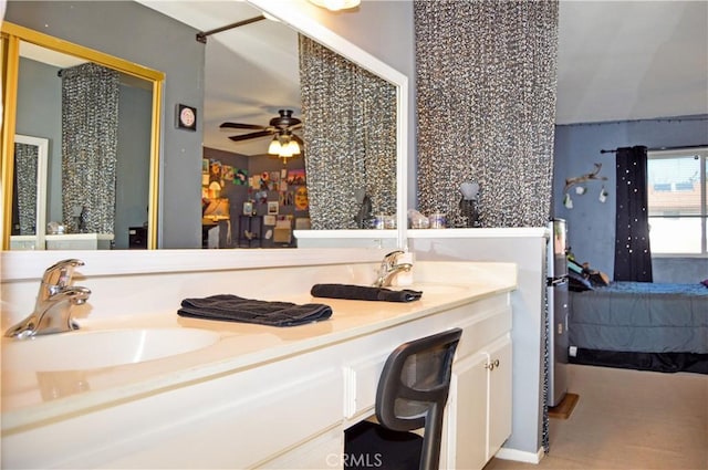 ensuite bathroom featuring double vanity, a sink, ceiling fan, and ensuite bath