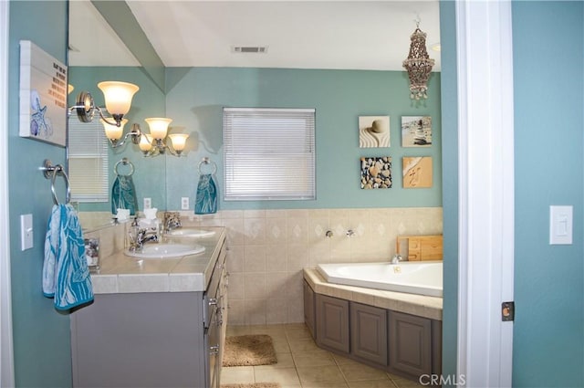 bathroom with a sink, a notable chandelier, double vanity, and visible vents