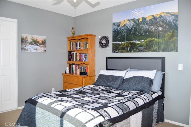 bedroom with carpet floors, baseboards, ceiling fan, and a mountain view
