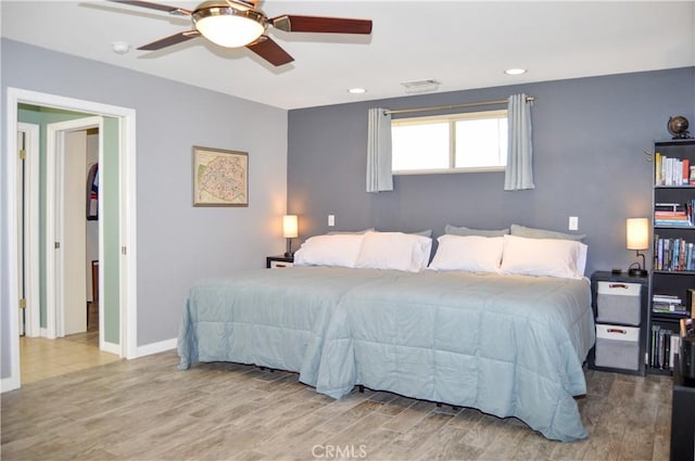 bedroom featuring recessed lighting, a ceiling fan, baseboards, and wood finished floors