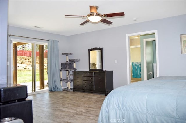 bedroom featuring ceiling fan, visible vents, access to exterior, and wood finished floors
