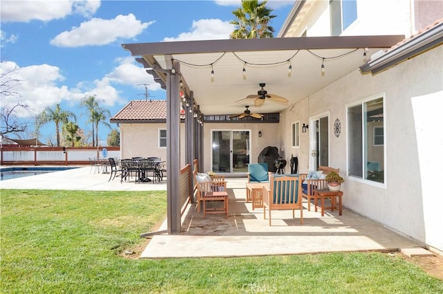 view of patio featuring fence, a fenced in pool, and ceiling fan