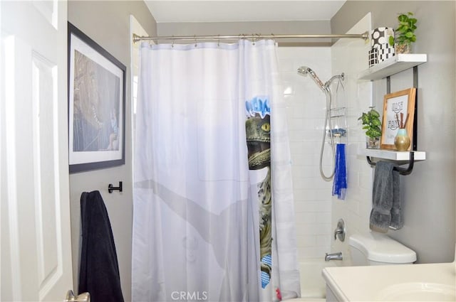 bathroom featuring shower / tub combo and toilet