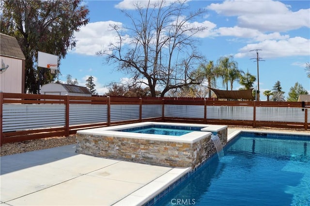 view of swimming pool with a pool with connected hot tub, a fenced backyard, and a patio area