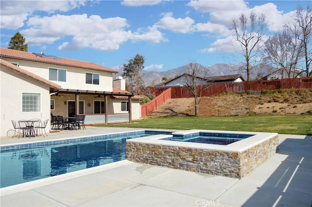 view of pool featuring a fenced backyard, a mountain view, outdoor dining area, a ceiling fan, and a patio