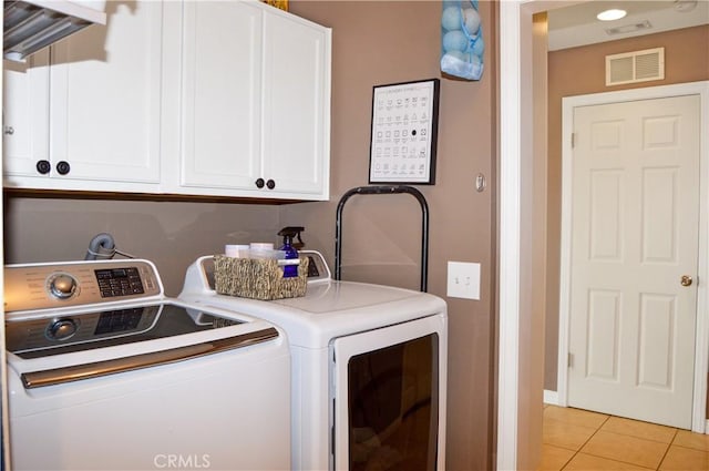 laundry room featuring light tile patterned floors, cabinet space, independent washer and dryer, and visible vents