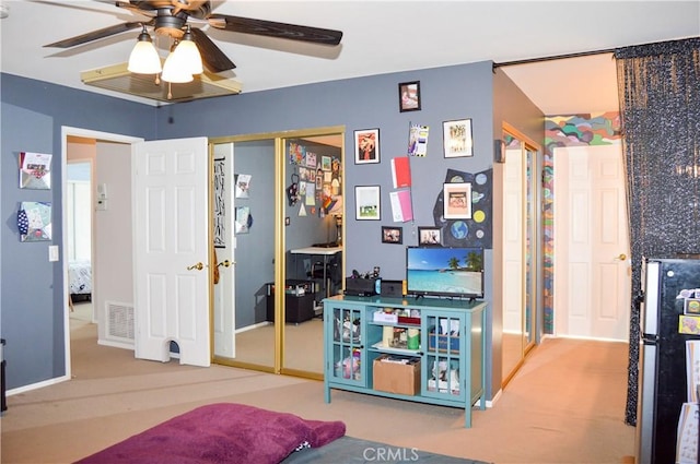 carpeted bedroom featuring two closets, a ceiling fan, baseboards, and visible vents