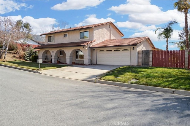 mediterranean / spanish house featuring a garage, a front lawn, fence, stucco siding, and concrete driveway