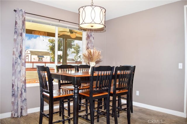 dining area with ceiling fan, baseboards, and wood finished floors