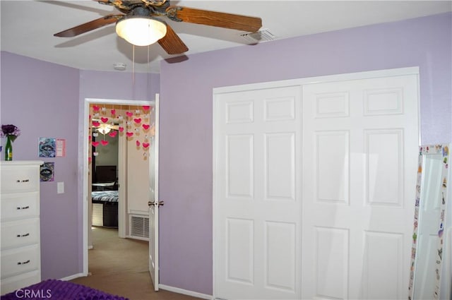 unfurnished bedroom with carpet floors, a ceiling fan, visible vents, and a closet