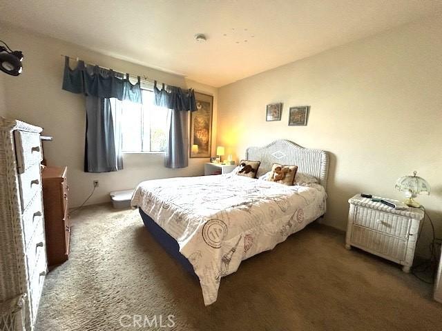 bedroom with dark colored carpet