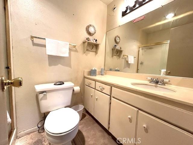 bathroom with vanity, toilet, and walk in shower