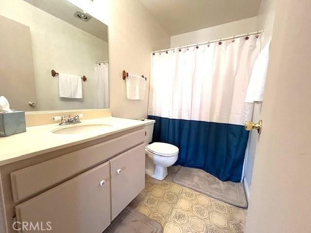 bathroom with vanity, tile patterned floors, and toilet