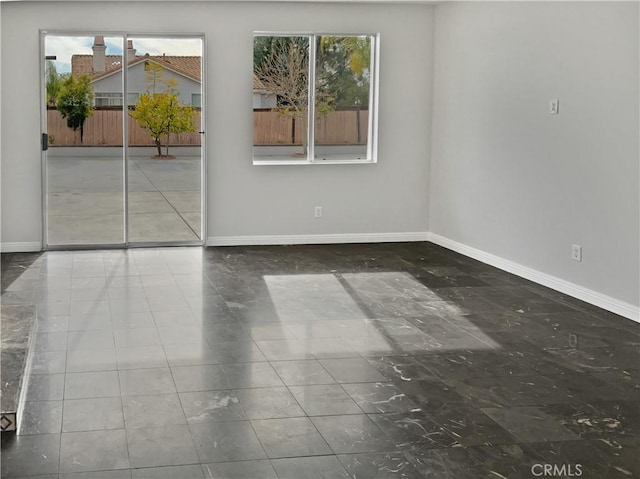 empty room featuring baseboards