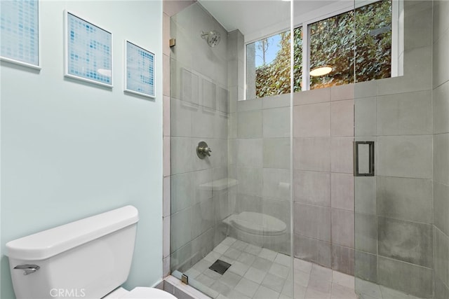 bathroom featuring toilet and an enclosed shower