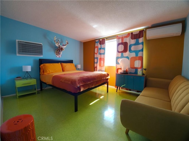 bedroom with a wall mounted AC and a textured ceiling