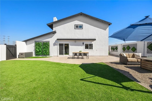 back of property with a patio, central air condition unit, stucco siding, a lawn, and fence