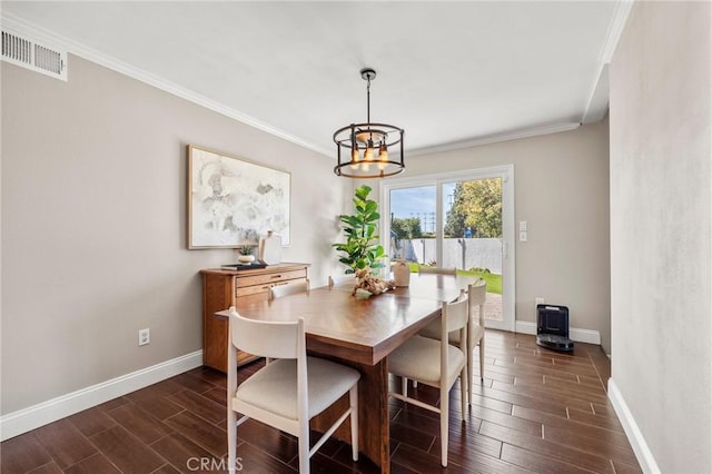 dining area featuring baseboards, ornamental molding, and wood tiled floor