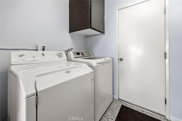 laundry area featuring washer and clothes dryer and cabinet space