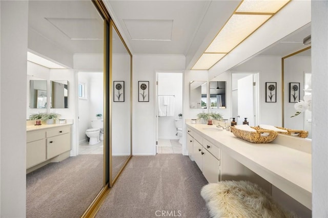 full bathroom with tile patterned flooring, vanity, toilet, and crown molding