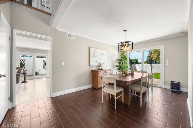 dining area with a wealth of natural light, visible vents, dark wood finished floors, and baseboards