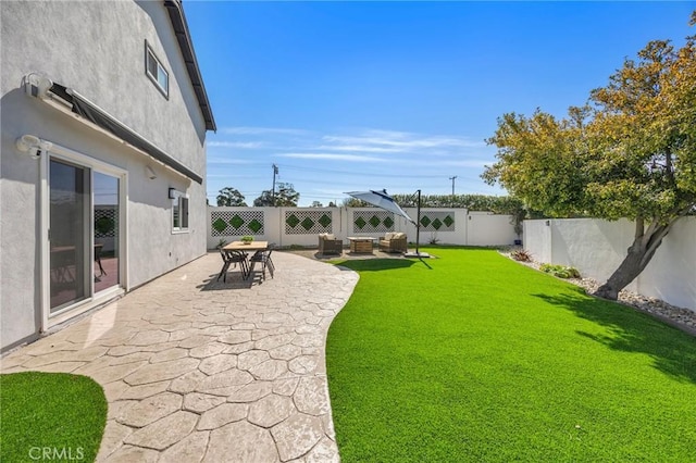 view of yard with a patio area and a fenced backyard