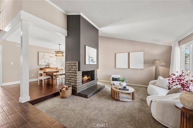 living room featuring lofted ceiling, wood finished floors, a multi sided fireplace, baseboards, and ornamental molding