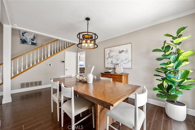 dining room featuring wood tiled floor, visible vents, stairway, and baseboards