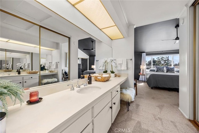 ensuite bathroom with ceiling fan, vanity, and ensuite bathroom