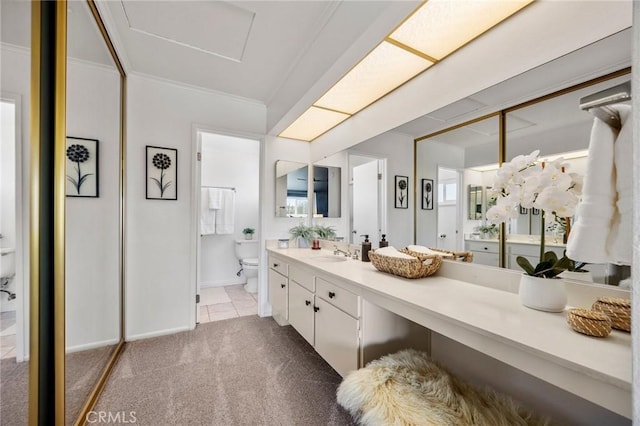 full bathroom with ornamental molding, vanity, toilet, and baseboards