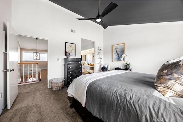 carpeted bedroom with a ceiling fan, visible vents, and high vaulted ceiling