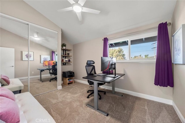 office space featuring vaulted ceiling, carpet, a ceiling fan, and baseboards