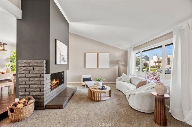 carpeted living area featuring ornamental molding, a brick fireplace, vaulted ceiling, and baseboards