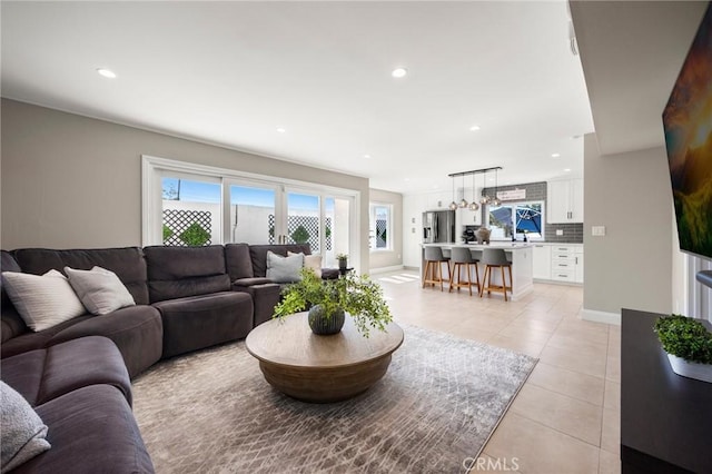 living area featuring recessed lighting, baseboards, and light tile patterned flooring