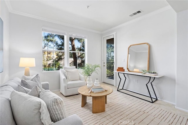 sitting room with ornamental molding, a wealth of natural light, visible vents, and light carpet