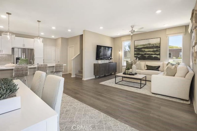 living room with ceiling fan and wood-type flooring