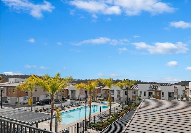 community pool featuring a residential view and fence