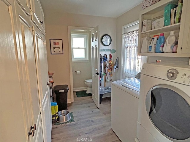 washroom featuring light hardwood / wood-style floors and washing machine and clothes dryer