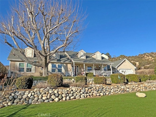 view of front of home with covered porch and a front lawn