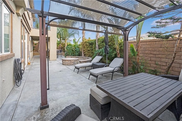 view of patio / terrace featuring a hot tub, a pergola, and a fire pit