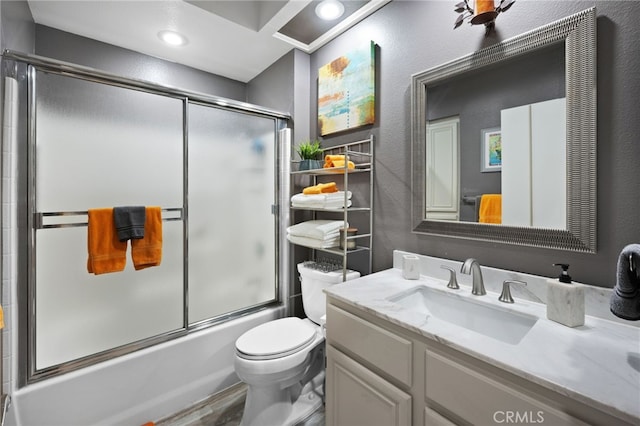 bathroom with toilet, shower / bath combination with glass door, wood finished floors, vanity, and recessed lighting