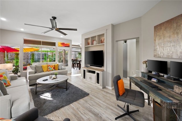 living room featuring light wood-style floors, recessed lighting, baseboards, and a ceiling fan