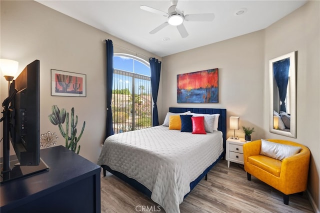 bedroom with a ceiling fan and wood finished floors