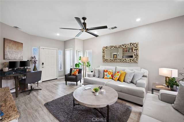 living area featuring light wood finished floors, recessed lighting, visible vents, and a ceiling fan