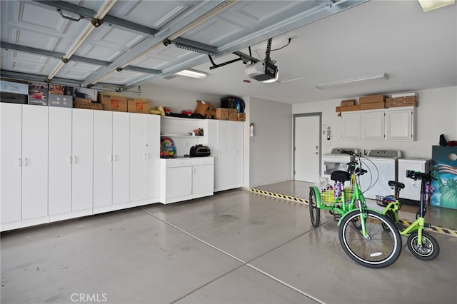 garage featuring washing machine and clothes dryer and a garage door opener