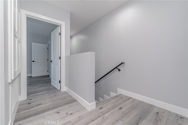 hallway with light hardwood / wood-style floors