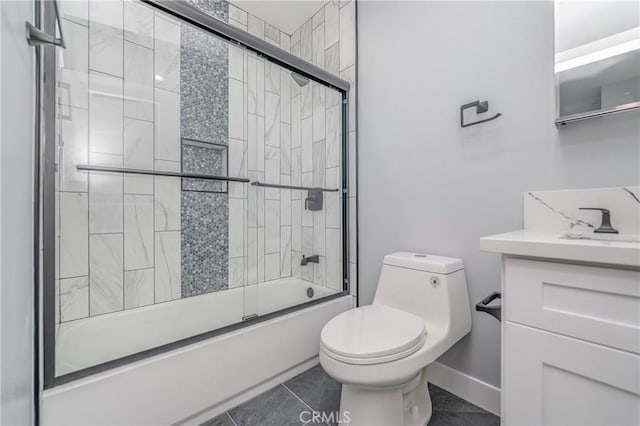 full bathroom featuring vanity, combined bath / shower with glass door, tile patterned floors, and toilet